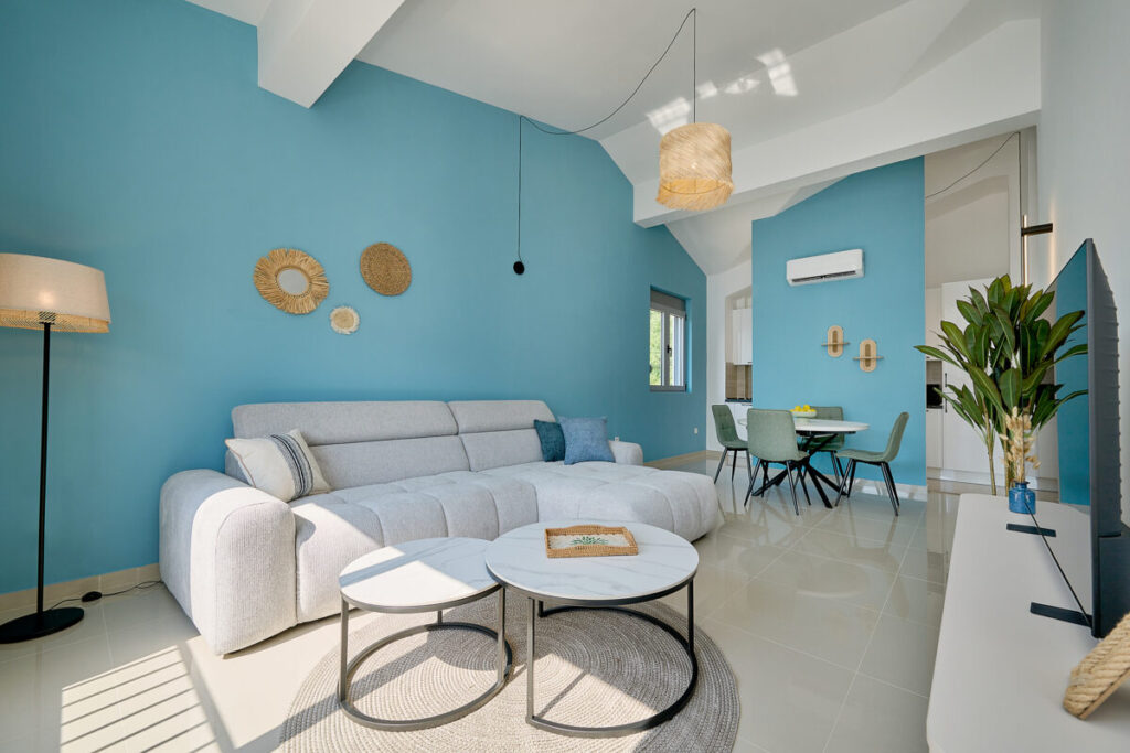 Sofa bed and coffee tables against blue wall of the living room - 2montenegro.me